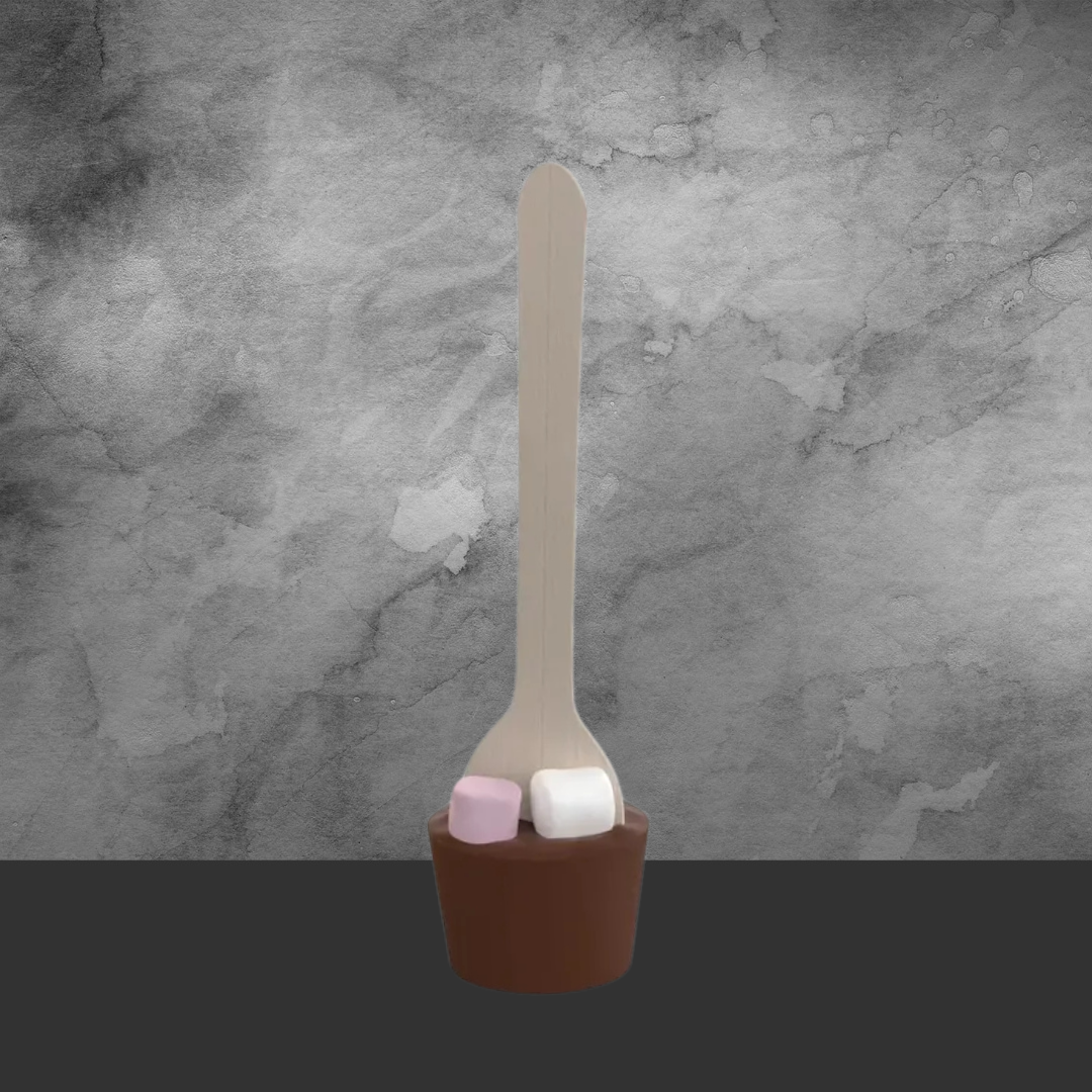 Chocolate spoon with pink and white marshmallows on wooden handle against gray textured background